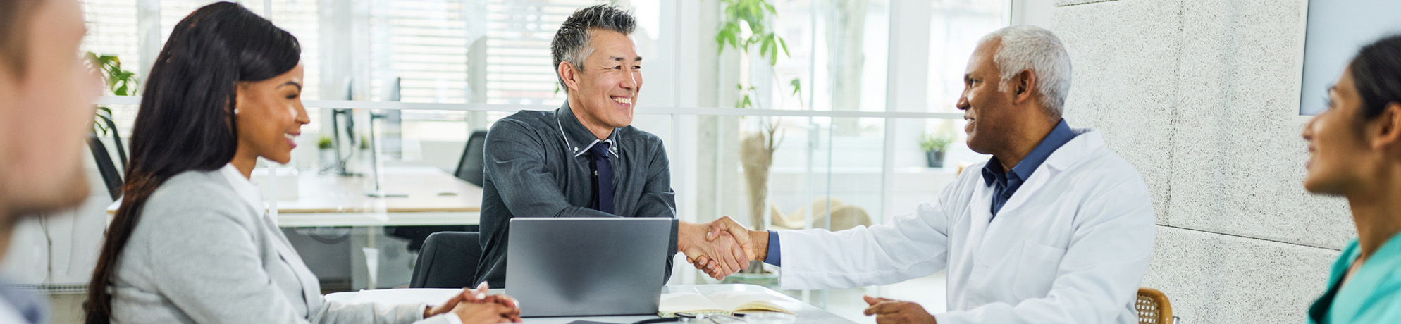 A business person and researcher shake hands