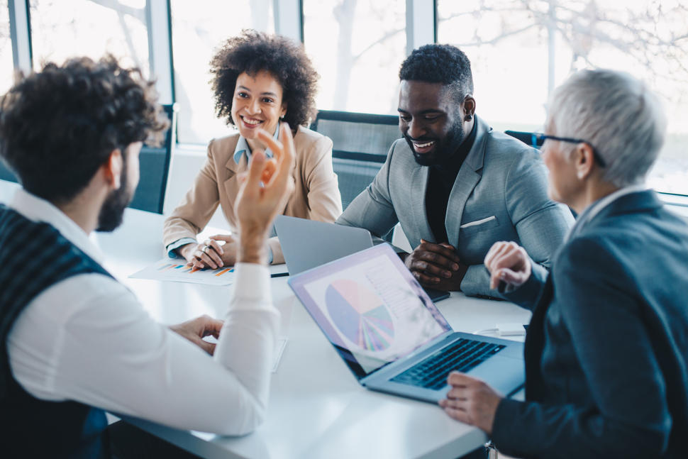 Young professionals at a meeting around a conference table