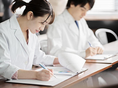 Researchers take notes to review publications